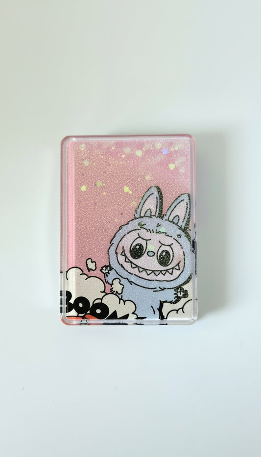 Pockett Mirror with Labubu character design on a pink glittery background